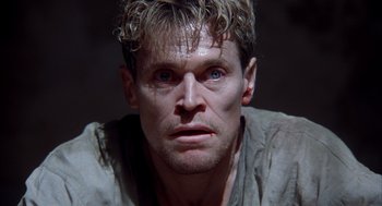 Movie still from “The English Patient” (1996), directed by Anthony Minghella – A person wearing a shirt; Close Up shot, Low angle