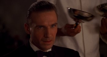 Movie still from “The English Patient” (1996), directed by Anthony Minghella – A person getting a hair cut; Close Up shot, Low angle