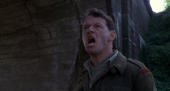 Movie still from “The English Patient” (1996), directed by Anthony Minghella – A man in a military jacket is yelling; Close Up shot, Low angle
