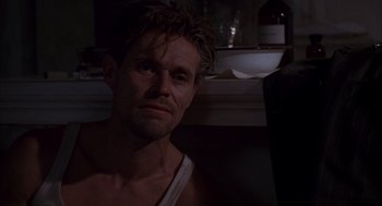 Movie still from “The English Patient” (1996), directed by Anthony Minghella – A person in a dark room; Close Up shot, Low angle