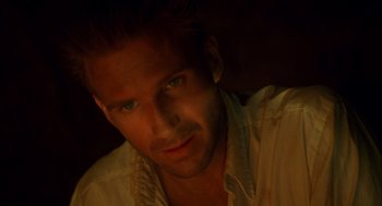 Movie still from “The English Patient” (1996), directed by Anthony Minghella – A person wearing a white shirt; Close Up shot, High angle