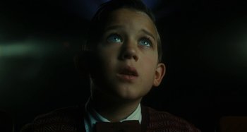 Movie still from “The Fabelmans” (2022), directed by Steven Spielberg – A young boy looking up into the dark; Close Up shot, Low angle