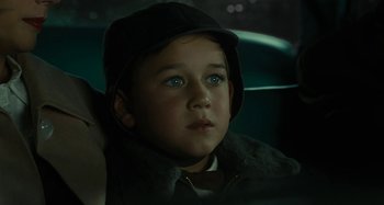Movie still from “The Fabelmans” (2022), directed by Steven Spielberg – A young boy sitting in the back seat of a car; Close Up shot, High angle