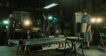 Movie still from “The Fabelmans” (2022), directed by Steven Spielberg – Two people in a room with a television set on a table; Wide shot, High angle