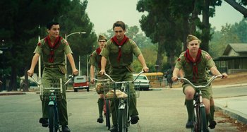 Movie still from “The Fabelmans” (2022), directed by Steven Spielberg – A group of young men riding bicycles down a street; Wide shot, Low angle
