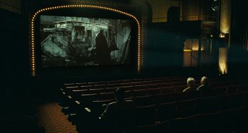 Movie still from “The Fabelmans” (2022), directed by Steven Spielberg – Two people sitting in a movie theater watching a movie; Extreme Wide shot, High angle