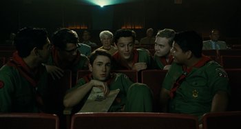 Movie still from “The Fabelmans” (2022), directed by Steven Spielberg – A group of young men sitting in a movie theater; Medium shot, Low angle