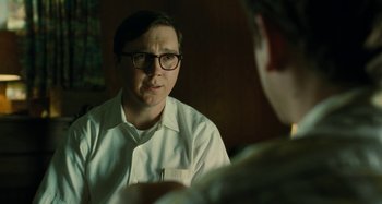 Movie still from “The Fabelmans” (2022), directed by Steven Spielberg – A man wearing glasses is sitting in front of another man; Close Up shot, Over the shoulder angle