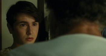 Movie still from “The Fabelmans” (2022), directed by Steven Spielberg – A young man looking at himself in the mirror; Close Up shot, Over the shoulder angle