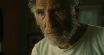 Movie still from “The Fabelmans” (2022), directed by Steven Spielberg – An older man with a beard and a white shirt; Close Up shot, Over the shoulder angle