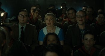 Movie still from “The Fabelmans” (2022), directed by Steven Spielberg – A group of people sitting in a dark room; Medium shot, Low angle