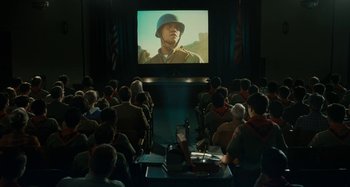 Movie still from “The Fabelmans” (2022), directed by Steven Spielberg – A group of people sitting in front of a projector screen; Wide shot, High angle