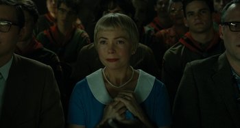 Movie still from “The Fabelmans” (2022), directed by Steven Spielberg – A woman in a blue dress and a white necklace; Close Up shot, Over the shoulder angle