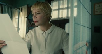 Movie still from “The Fabelmans” (2022), directed by Steven Spielberg – A woman smoking a cigarette while wearing a white shirt; Close Up shot, Low angle