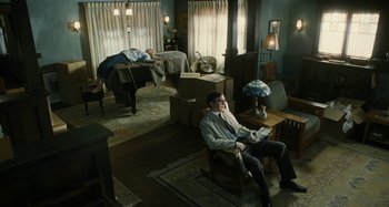 Movie still from “The Fabelmans” (2022), directed by Steven Spielberg – A man sitting on a chair in a living room; Wide shot, High angle