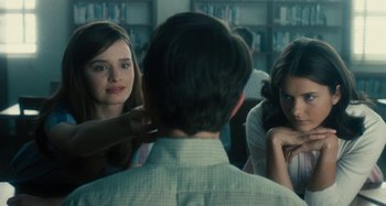 Movie still from “The Fabelmans” (2022), directed by Steven Spielberg – A man and two women in a library; Close Up shot, Over the shoulder angle