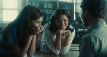 Movie still from “The Fabelmans” (2022), directed by Steven Spielberg – Two women sitting at a table in front of a book shelf; Medium shot, Over the shoulder angle