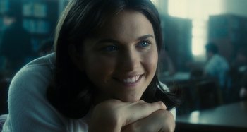 Movie still from “The Fabelmans” (2022), directed by Steven Spielberg – A person smiling with her hand on her chin; Close Up shot, Over the shoulder angle