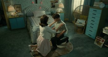 Movie still from “The Fabelmans” (2022), directed by Steven Spielberg – A young man and a young woman in a bedroom; Wide shot, High angle