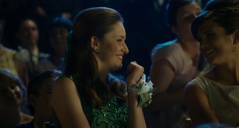 Movie still from “The Fabelmans” (2022), directed by Steven Spielberg – A woman in a green dress is smiling; Close Up shot, Over the shoulder angle