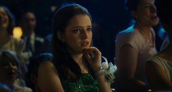 Movie still from “The Fabelmans” (2022), directed by Steven Spielberg – A woman in a green dress is sitting down; Close Up shot, Over the shoulder angle