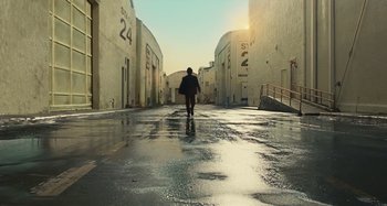 Movie still from “The Fabelmans” (2022), directed by Steven Spielberg – A person walking down a street in a city; Extreme Wide shot, Low angle