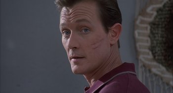 Movie still from “The Faculty” (1998), directed by Robert Rodriguez – A person with a scar on his face; Close Up shot, Over the shoulder angle