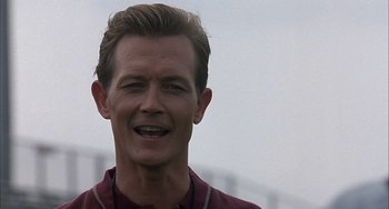 Movie still from “The Faculty” (1998), directed by Robert Rodriguez – A person with a beard smiling; Close Up shot, Low angle