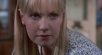 Movie still from “The Faculty” (1998), directed by Robert Rodriguez – A woman's face with long blond hair; Close Up shot, Over the shoulder angle