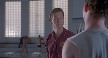 Movie still from “The Faculty” (1998), directed by Robert Rodriguez – A man in a red shirt is looking at himself in the mirror; Close Up shot, Over the shoulder angle