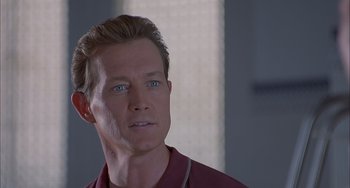 Movie still from “The Faculty” (1998), directed by Robert Rodriguez – A person wearing a red shirt; Close Up shot, Low angle