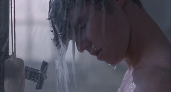 Movie still from “The Faculty” (1998), directed by Robert Rodriguez – A woman is taking a shower in the rain; Close Up shot, Low angle