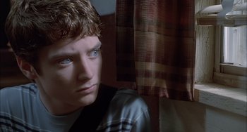 Movie still from “The Faculty” (1998), directed by Robert Rodriguez – A young man sitting in front of a window; Close Up shot, Low angle
