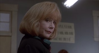 Movie still from “The Faculty” (1998), directed by Robert Rodriguez – A person wearing a black jacket; Close Up shot, Low angle