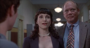 Movie still from “The Faculty” (1998), directed by Robert Rodriguez – A woman in a black suit and a man in a suit; Close Up shot, Low angle