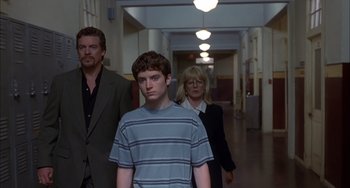 Movie still from “The Faculty” (1998), directed by Robert Rodriguez – A group of people walking down a hall way; Medium shot, Low angle