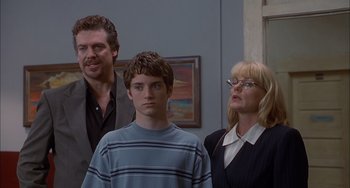 Movie still from “The Faculty” (1998), directed by Robert Rodriguez – A man and two women standing next to a young boy; Medium shot, Over the shoulder angle
