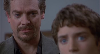 Movie still from “The Faculty” (1998), directed by Robert Rodriguez – A man and a boy looking at the camera; Close Up shot, Over the shoulder angle