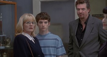 Movie still from “The Faculty” (1998), directed by Robert Rodriguez – Two men and a woman standing next to each other in a room; Medium shot, Over the shoulder angle