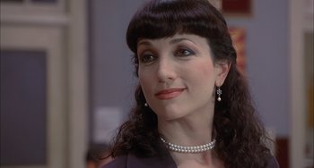 Movie still from “The Faculty” (1998), directed by Robert Rodriguez – A person wearing a necklace; Close Up shot, Over the shoulder angle