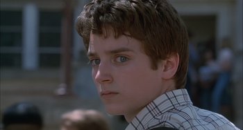 Movie still from “The Faculty” (1998), directed by Robert Rodriguez – A young man with a serious look on his face; Close Up shot, Low angle
