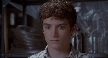 Movie still from “The Faculty” (1998), directed by Robert Rodriguez – A young man with blue eyes stares into the camera; Close Up shot, Low angle