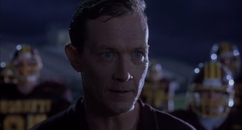 Movie still from “The Faculty” (1998), directed by Robert Rodriguez – A person wearing a shirt; Close Up shot, Low angle
