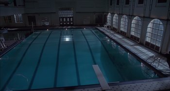 Movie still from “The Faculty” (1998), directed by Robert Rodriguez – An empty swimming pool in an indoor swimming pool; Extreme Wide shot, High angle