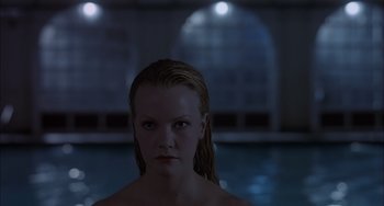 Movie still from “The Faculty” (1998), directed by Robert Rodriguez – A woman with wet hair standing in front of a swimming pool; Close Up shot, Over the shoulder angle
