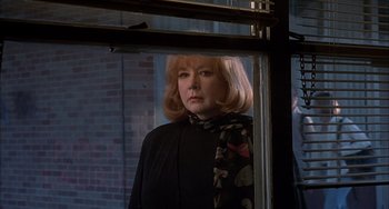 Movie still from “The Faculty” (1998), directed by Robert Rodriguez – A woman standing in front of a window; Close Up shot, Over the shoulder angle
