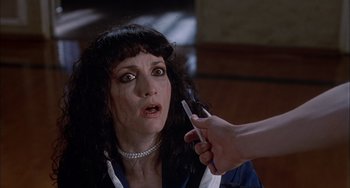 Movie still from “The Faculty” (1998), directed by Robert Rodriguez – A woman is on her phone and looking surprised; Close Up shot, High angle
