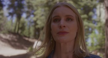 Movie still from “The Field Guide to Evil” (2018), directed by Can Evrenol – A person with long blonde hair; Close Up shot, Low angle