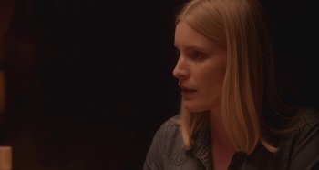 Movie still from “The Field Guide to Evil” (2018), directed by Can Evrenol – A woman with long blonde hair looking to her left; Close Up shot, Over the shoulder angle