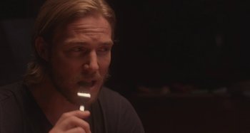 Movie still from “The Field Guide to Evil” (2018), directed by Can Evrenol – A person holding a toothbrush in his mouth; Close Up shot, Over the shoulder angle